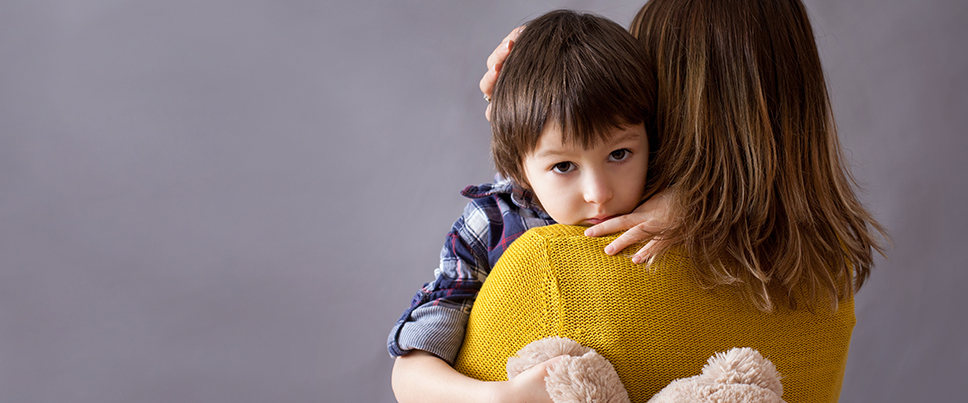 Boy being held by mother