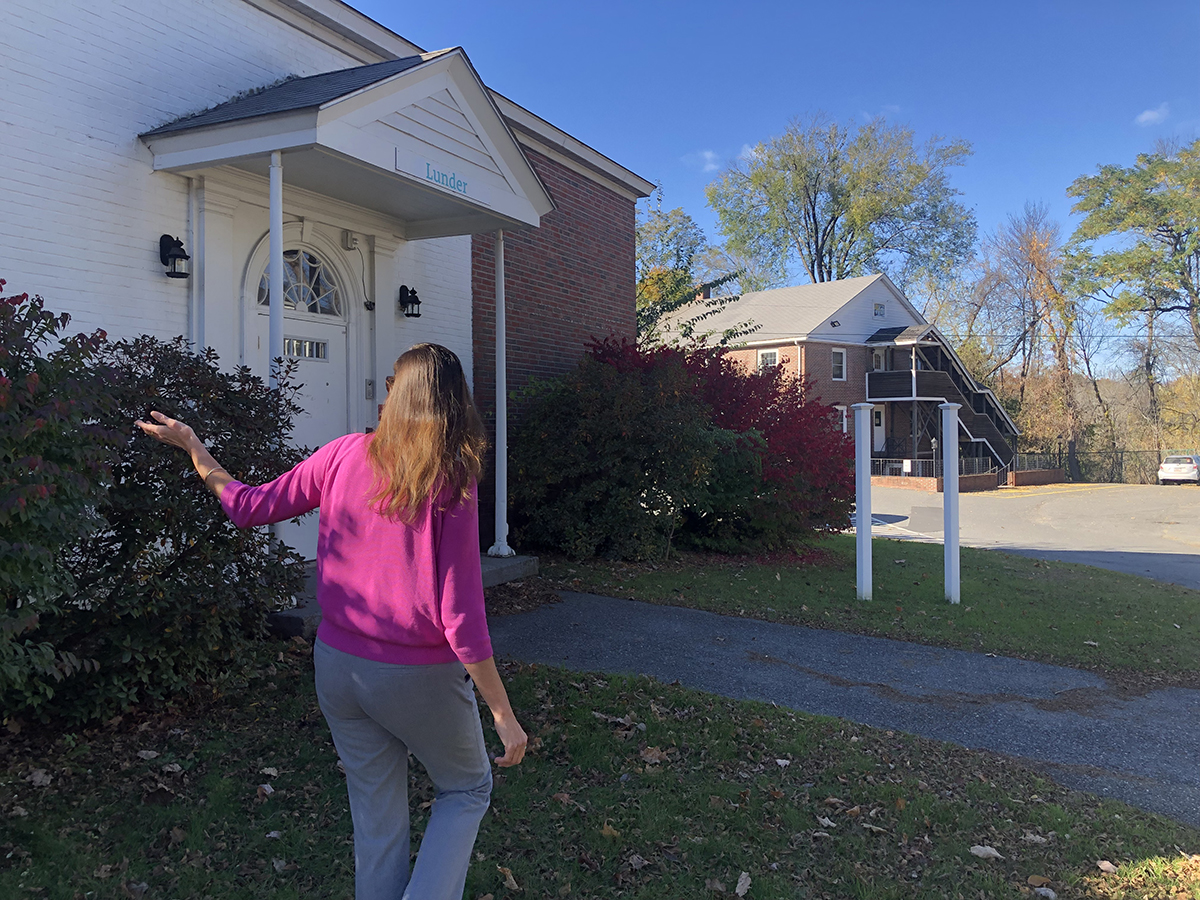 Executive Director Candace Marriner gives tour of the outside of a building that will be renovated thanks to congressional directed spending that was awarded to Maine Children's Home in 2023.