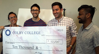 From left to right: Lindsay Bragdon of The Maine Children's Home accepts grant money from Colby College students Jordan Nathan, Aquib Yacoob, and Brad Gaffin.