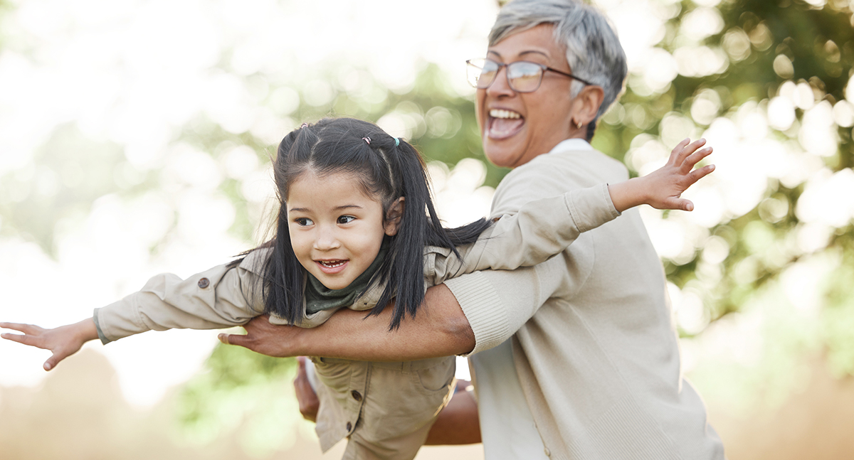Grandmother and young granddaughter play outside