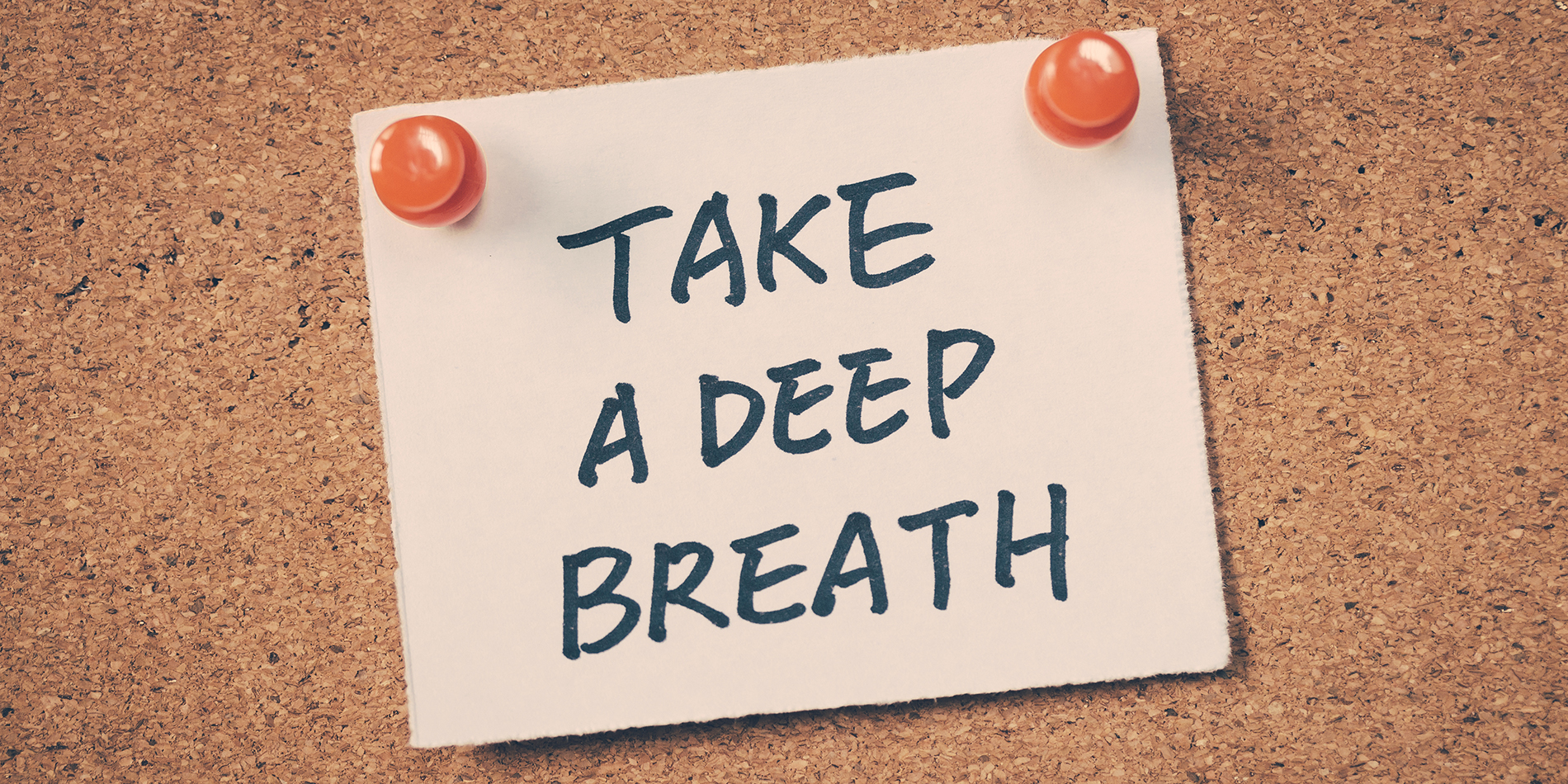 A post-it that says "take a deep breath"