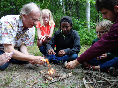 Campers at a Maine Childrens Home summer camp learning how to build a fire