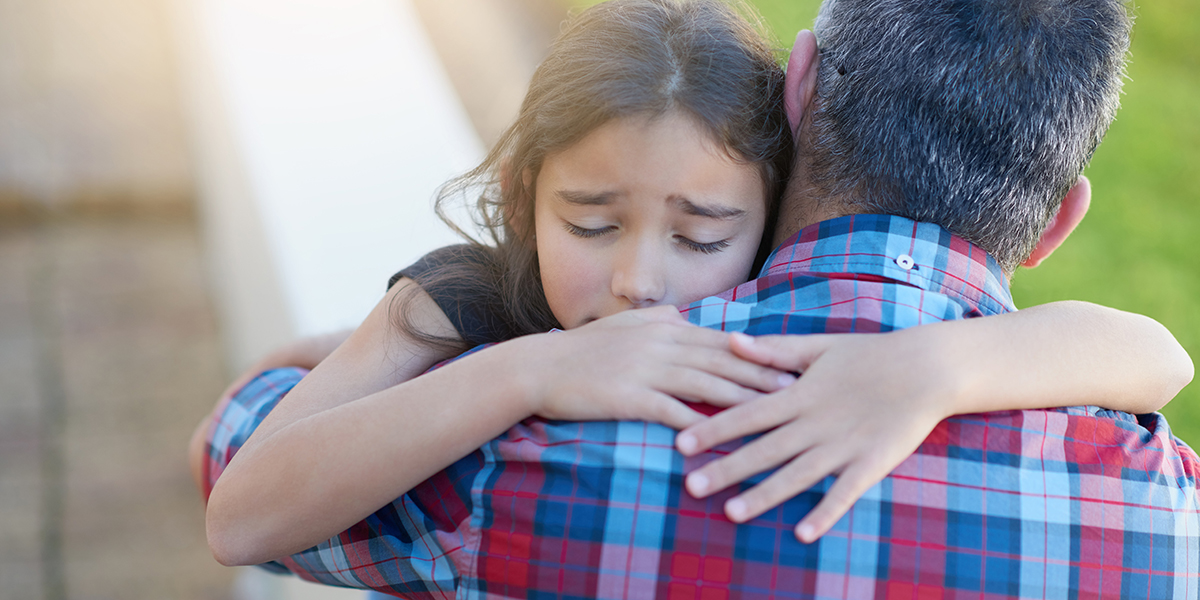 A father and daughter hug